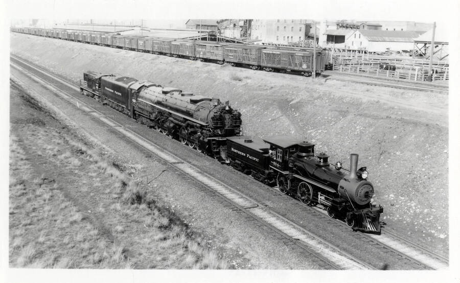 Two train engines, NP&I no. 4, and NP 5139, being towed to Spokane for an exhibition showing.