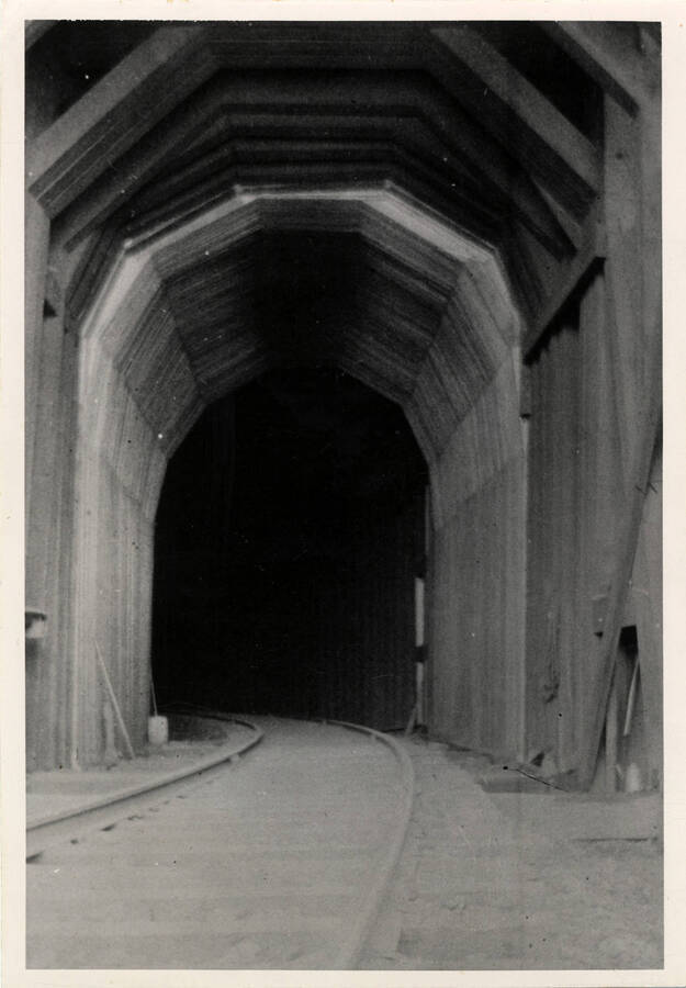 A photograph of Tunnel No. 7 on the Lapwai Branch of the Camas Prairie Railroad. The view was taken to show the solid timber lining inside the portal at the Grangeville end of the tunnel.