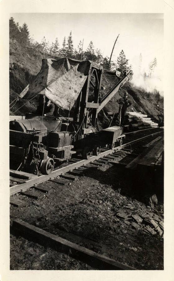 A photograph of a construction vehicle on the tracks near Bridge 5, across Orofino Creek.