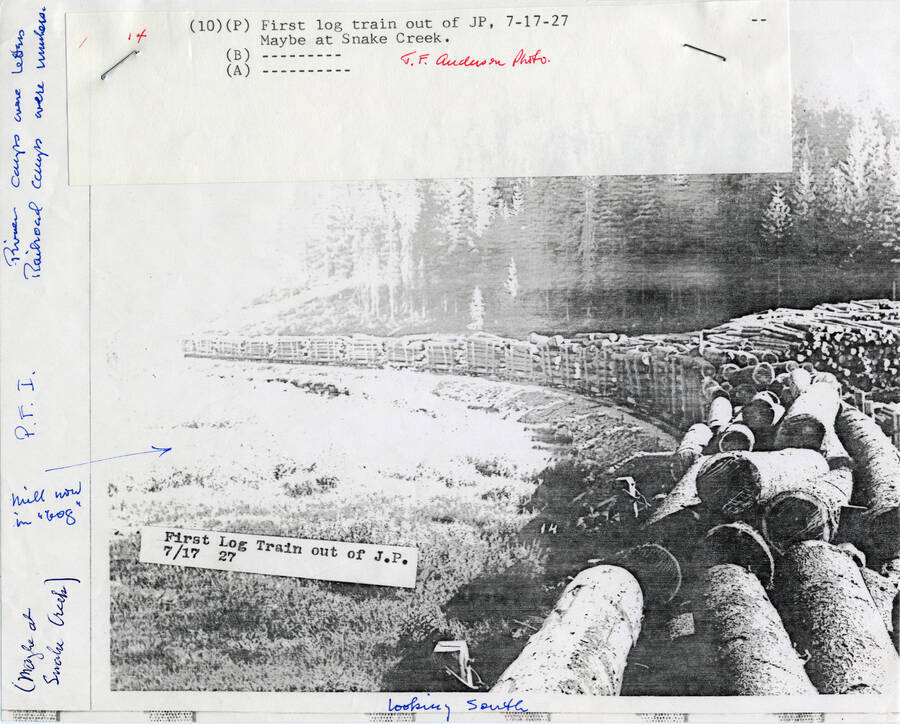 A paper copy of a photograph of the first log train out of JP, looking south.