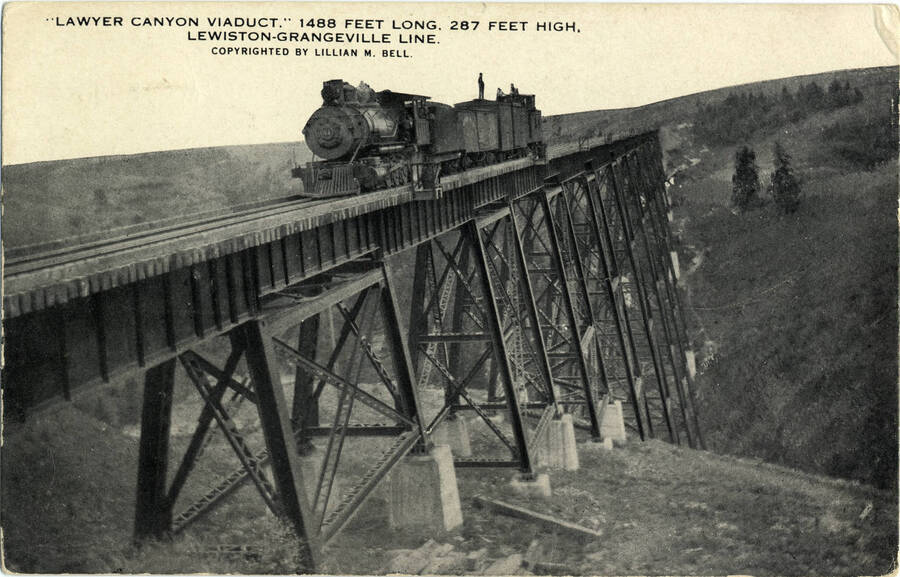A postcard of the Lawyer Canyon Viaduct, which is 1,488 feet long and 287 feet high. This bridge is part of the Lewiston-Grangeville line of the Camas Prairie Railroad.