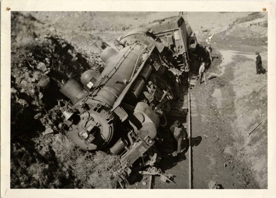A photograph of derailed Union Pacific Train Engine 2881. 'Passenger service between Lewiston and Ayer Junction. Equipped with acknowledging devices and primitive automatic Traincontrol used on Union Pacific mainline.' - Bill Clem