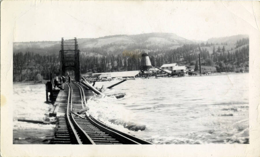 A photograph of a damaged railroad leading up to Kamiah Bridge in Kamiah, Idaho.