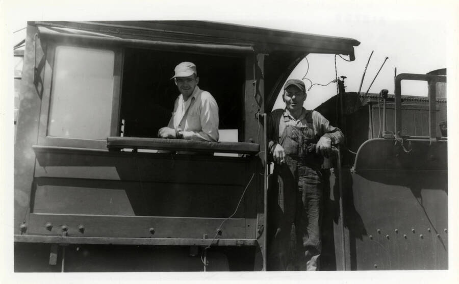 A photograph of Engineer Odell (in the gangway), and Fireman Cash inside of NP&I 9.