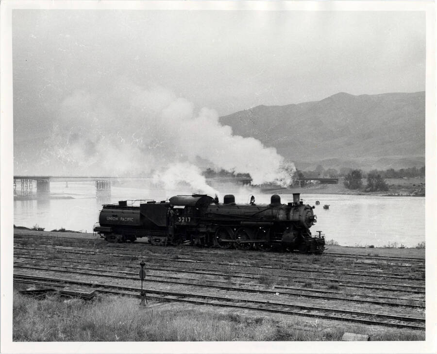 A photograph of train engine #3217 just coming in from Riparia with train #74. The picture takes place at the west end of the East Lewiston Train Yard, the engine on its way to the engine terminal.