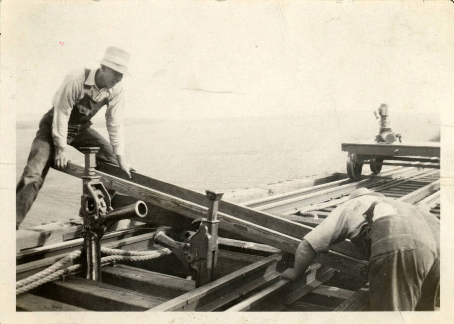 Two railroad workers building the railroad atop bridge 38 on the Camas Prairie Railroad