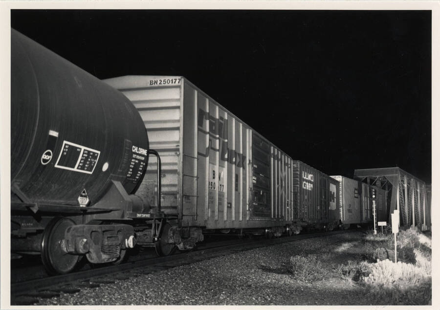 Union Pacific freight train No. 3154 passing over a bridge at night.