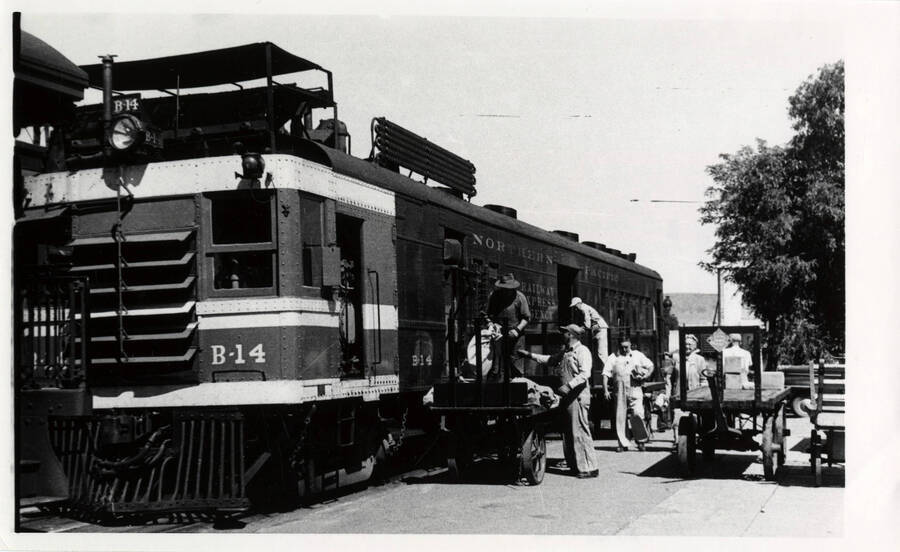 A photograph of Express Train B14 arriving from Grangeville at the Lewiston Depot, the mail and express being unloaded.