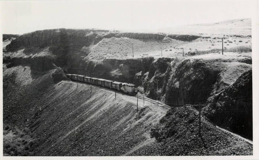 A photograph of UP freight train headed for Spokane on Hinkle-Spokane mainline, near Palouse Falls.