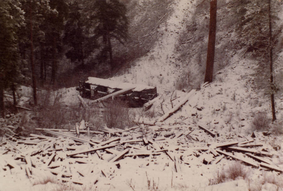 A color photograph of what appears to be a runaway freight car covered in snow.
