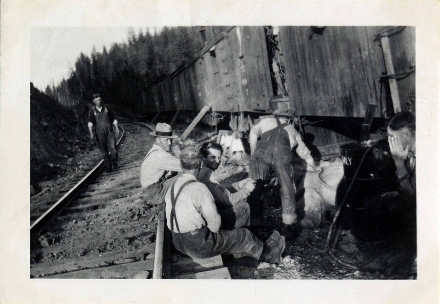 A group of railroad workers taking a break and enjoying each others' company on the side of the railroad, on the road between Orofino and Headquarters.
