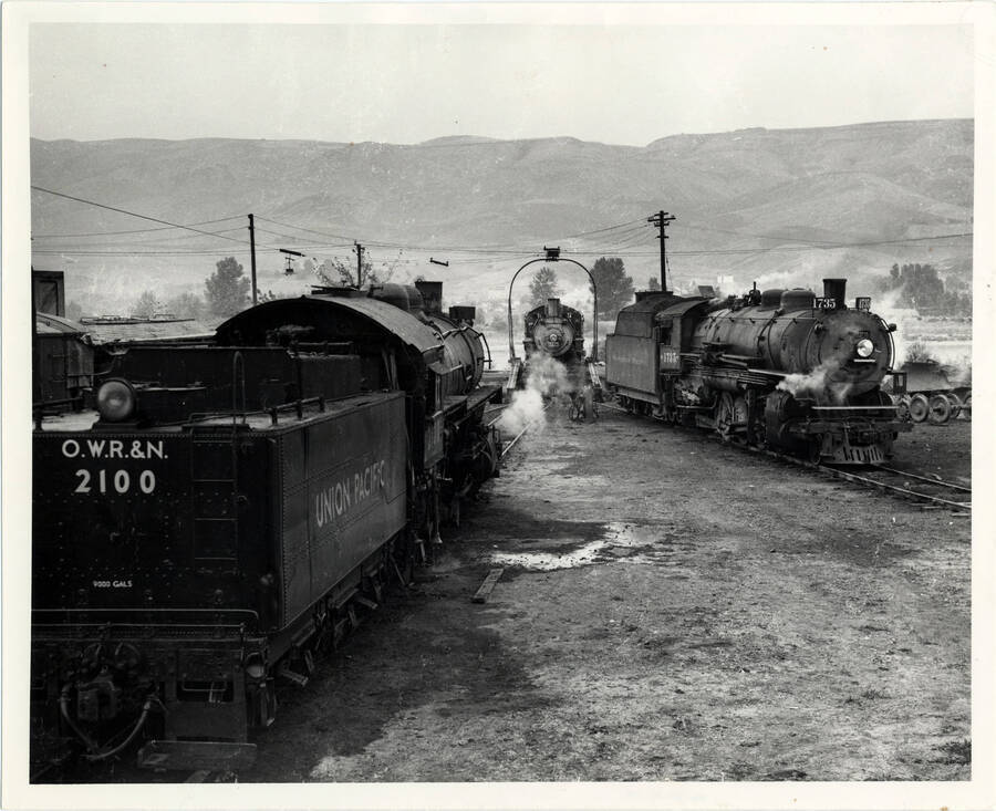 A photograph of train engine #3217 on table, while two other engines stand by in the East Lewiston Train Yard.