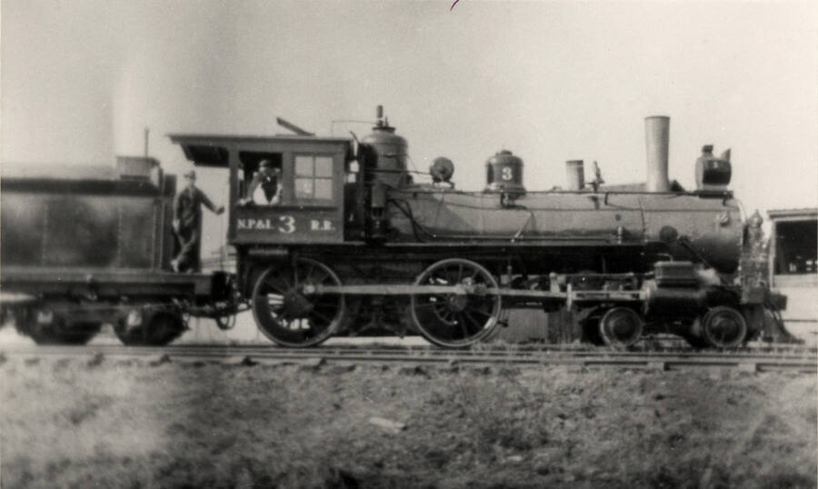 A photograph of 4-4-0 Number 3, lettered for the predecessor NezPerce and Idaho Railroad, poses with engineer Sam Stenseon and fireman Alva Senters in the summer of 1925. Long an institution on this Idaho common carrier, the Number 3 would work at NezPerce for another 25 years before a deserved retirement would come. Photographed by Ray Thomas and collected by Ken Brovald.