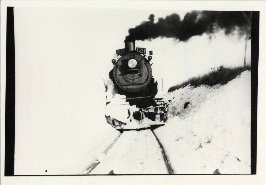 Northern Pacific Train Engine 1506 moving through plowed tracks in the winter of 1950 on the Grangeville Branch of the Camas Prairie Railroad.