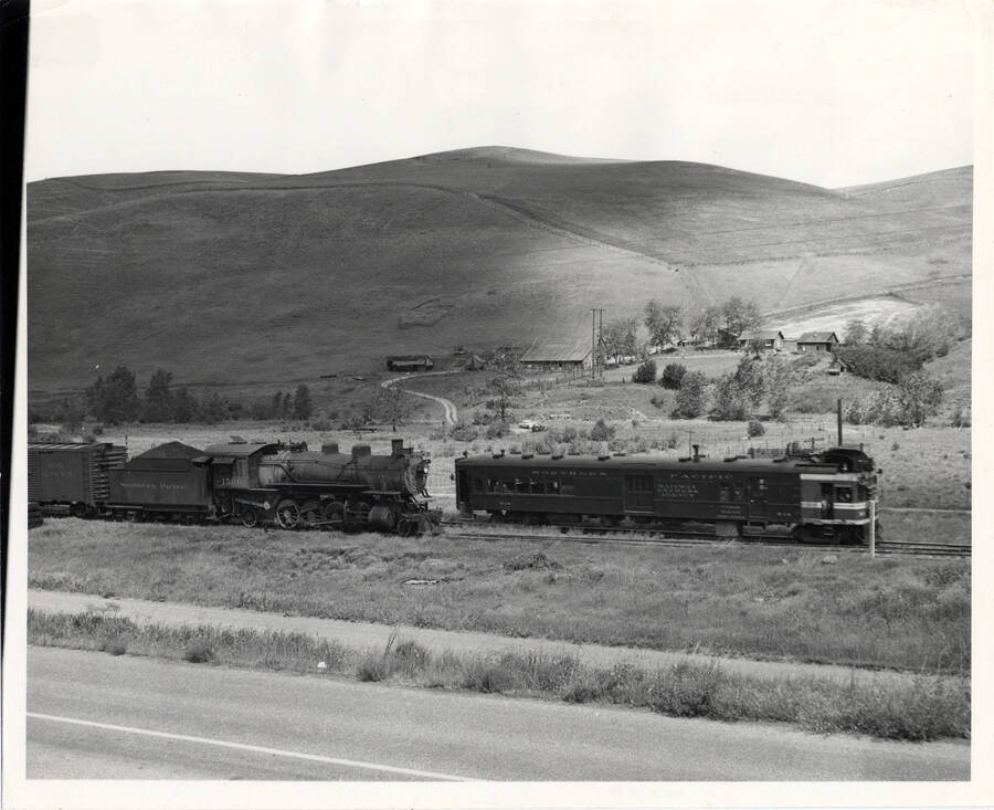 A photograph of Train #344 running through Lapwai Creek Valley on its way to Grangeville, passing motor B-14 in the process.
