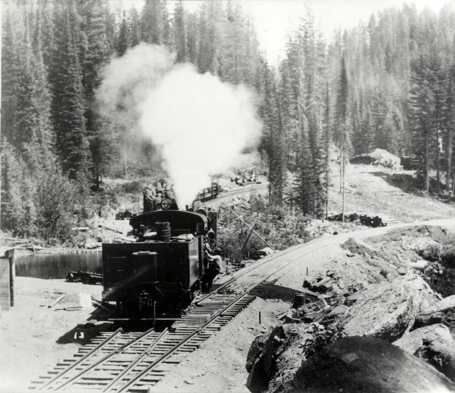 A photograph of a train engine transporting lumber in Potlatch, Idaho.
