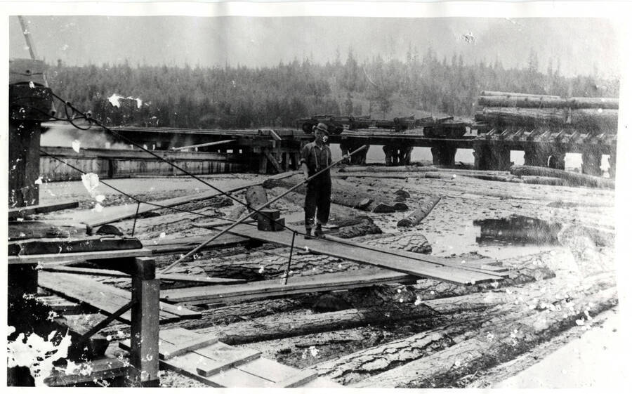 Log dumping pond on Winchester Lake pictured with a Mill worker