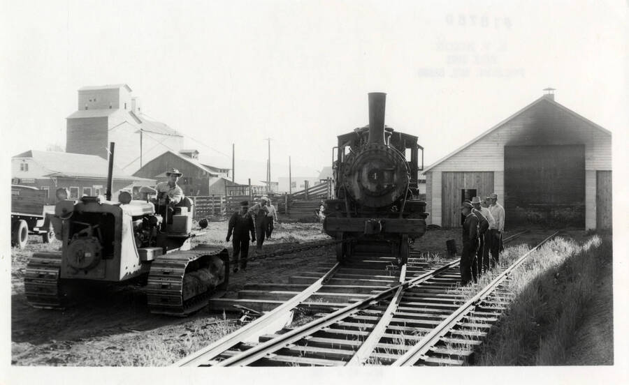 A photograph of a CAT finally dragging NezPerce & Idaho Train Engine 4 out of its place of abandonment.