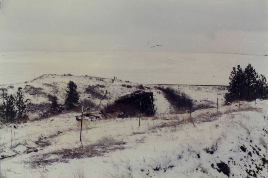 A color photograph of a snowy landscape, assumed to have been taken from a train.