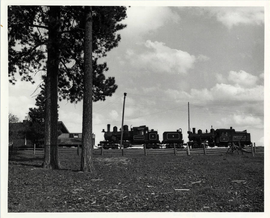 A photograph of a few stationary train motors located near the Winchester, Idaho train depot.
