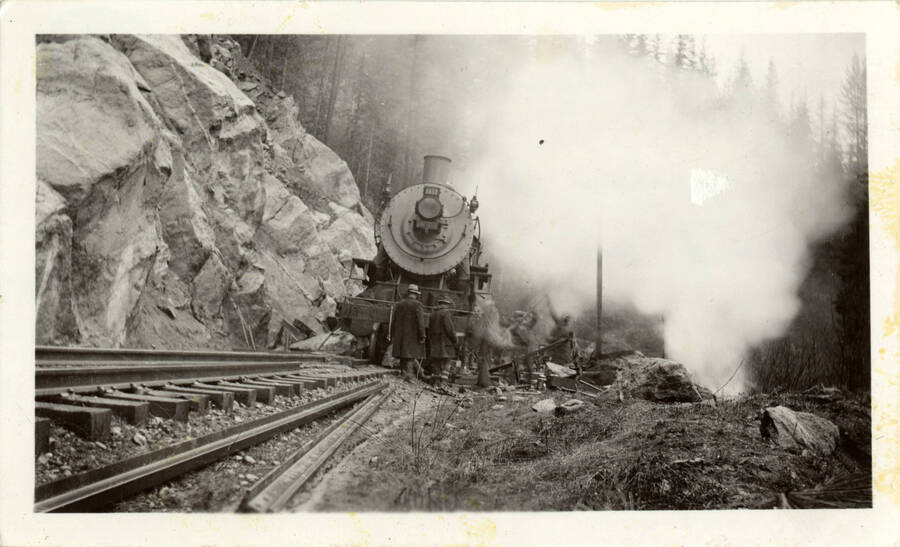 A photograph of crashed train #1618 near Lenore, Idaho. The crash occurred because the engineer fell asleep and didn't see the oncoming rock slide.