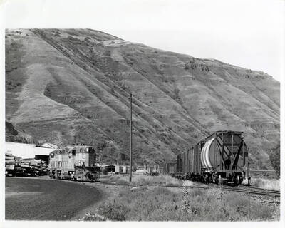Train No. 858 switching loaded log flats into the small lumber mill at North Lapwai before turning off the first subdivision at Spalding.