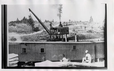 Logging camp with what appears to be a logging crane behind it
