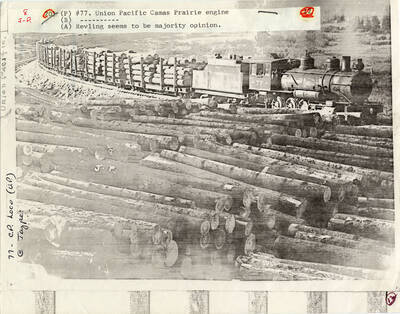 A paper copy of a photograph of Train Engine #77, belonging to Union Pacific Camas Prairie, carrying a large lumber load.