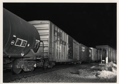 Union Pacific freight train No. 3154 passing over a bridge at night.