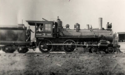 A photograph of 4-4-0 Number 3, lettered for the predecessor Nez Perce and Idaho Railroad, poses with engineer Sam Stenseon and fireman Alva Senters in the summer of 1925. Long an institution on this Idaho common carrier, the Number 3 would work at Nez Perce for another 25 years before a deserved retirement would come. Photographed by Ray Thomas and collected by Ken Brovald.