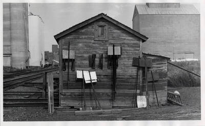 Tool and handcar shed of standard NP design at Grangeville, with grain elevators in the background. NP originally built the Grangerville line, and all the original railroad structures were of NP design.