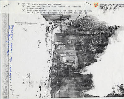 A paper copy of a photograph of a PFI steam engine and caboose at Potlatch Forest Inc. in Headquarters, Idaho. Snow plow stores for years at Potlatch.