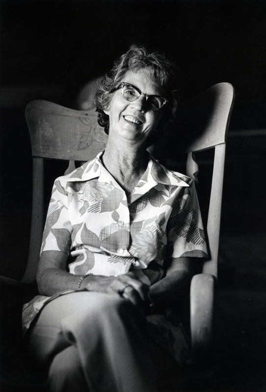 Photograph of Leah Brown sitting, smiling at the camera.