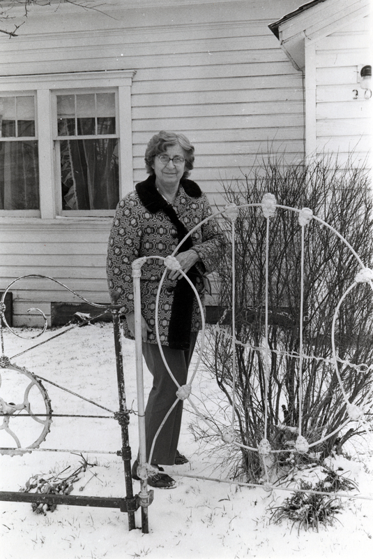 Photograph of Myrtle Gallager standing outside in winter, smiling at the camera.