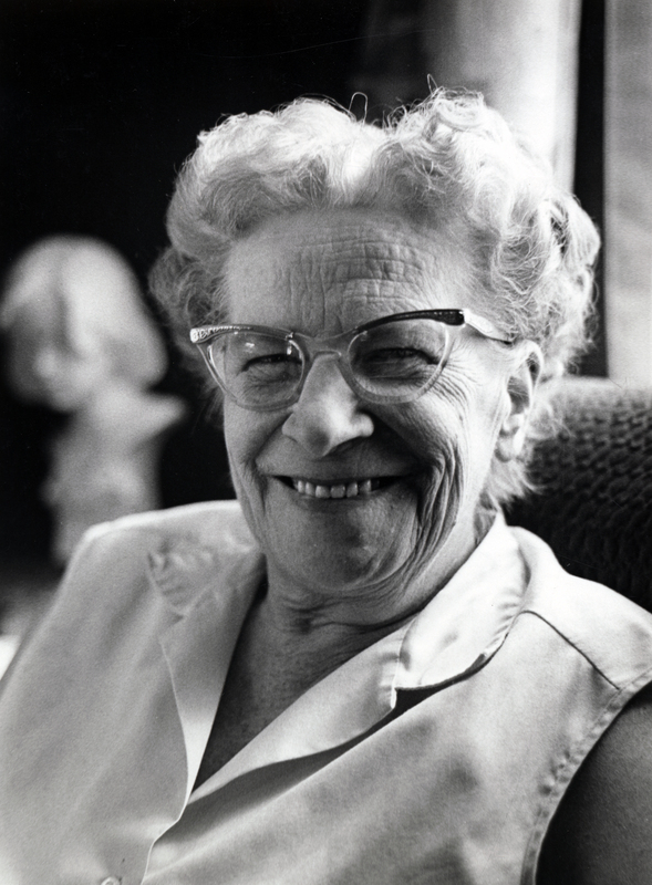 Photograph of Ruth Evelyn Lidlow seated, smiling at the camera.