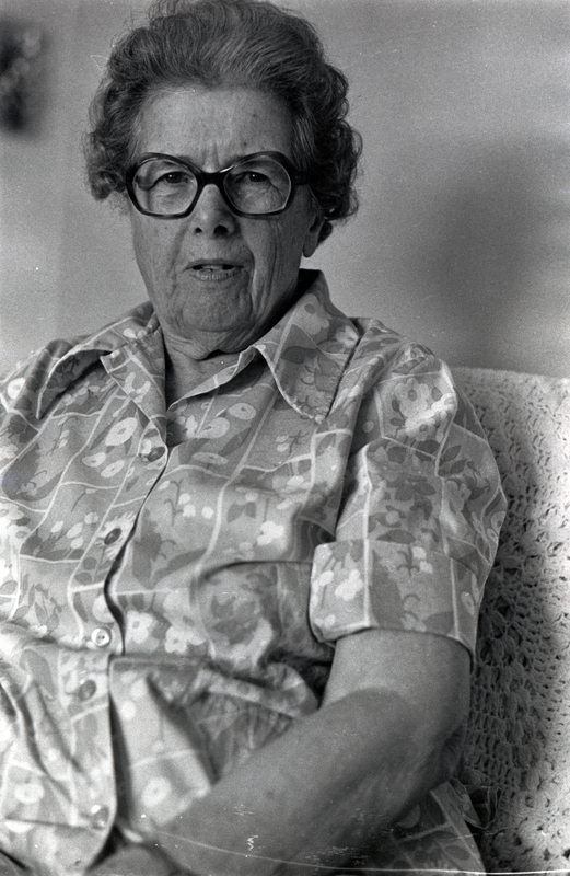 Photograph of Anne Reidhaar seated, looking at the camera.