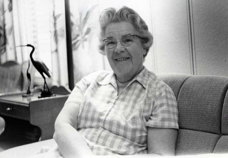 Photograph of Lillian Yangel seated, smiling at the camera.