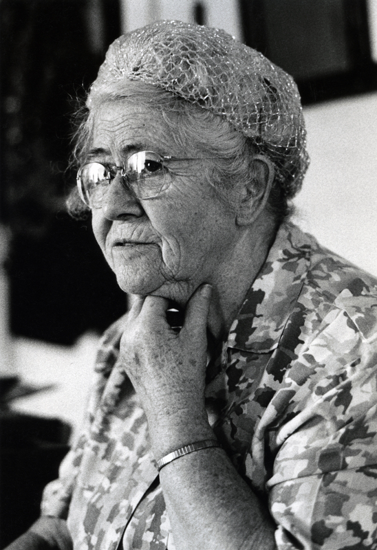 Photograph of Nellie Smith seated, looking away from the camera.