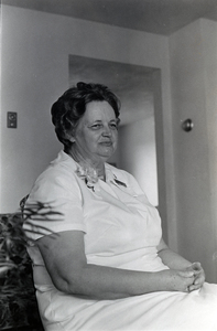 Photograph of Elizabeth Hart sitting, looking away from the camera.