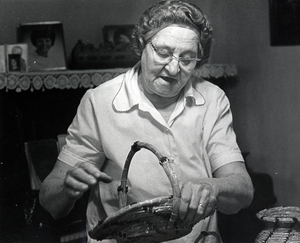 Photograph of Ella Margaret Hamann looking down at a basket she's holding.