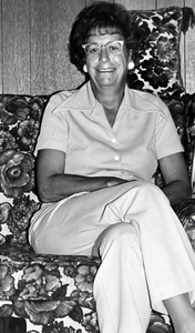 Photograph of Phyllis McArthur seated, smiling at the camera.