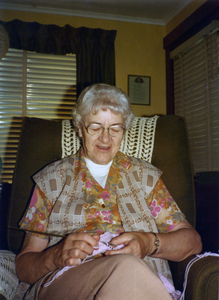 Color photograph of Mabel Louise Scribner seated, smiling at the camera.
