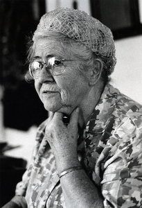 Photograph of Nellie Smith seated, looking away from the camera.