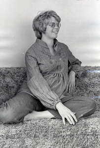 Photograph of Jana Shields seated, smiling away from the camera.