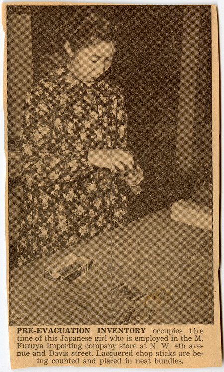 Newspaper clipping from Oregon Journal showing a woman inventorying chopsticks in the M. Furuya Importing company store in Portland, OR.