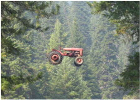 A farm tractor being airlifted out of the wilderness after the Forest Service acquired the Seminole Ranch in 2007.