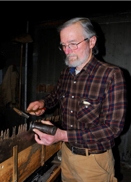 Warren Miller sharpening a saw in 2010