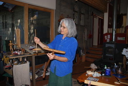 Sarah Swett, demonstrating the first handcrafted spindle she used to spin yarn