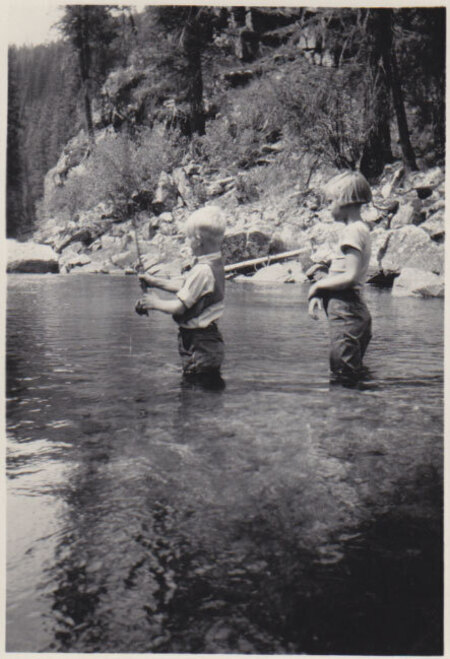Jean with her brother Jim who is trying out Jean's new fishing pole, across from the mouth of Bear Creek on the Selway River, 1939-40