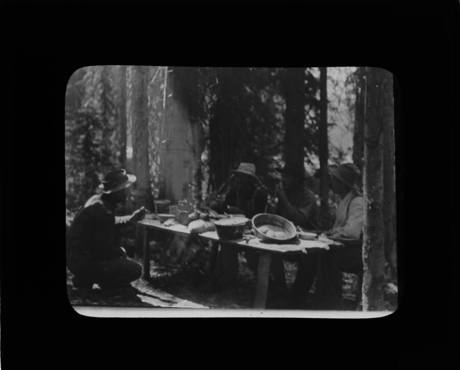 The glass slide reads: 'Forest rangers at dinner - White Sand Lake.'